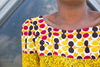 Colorful African print blouse and yellow skirt